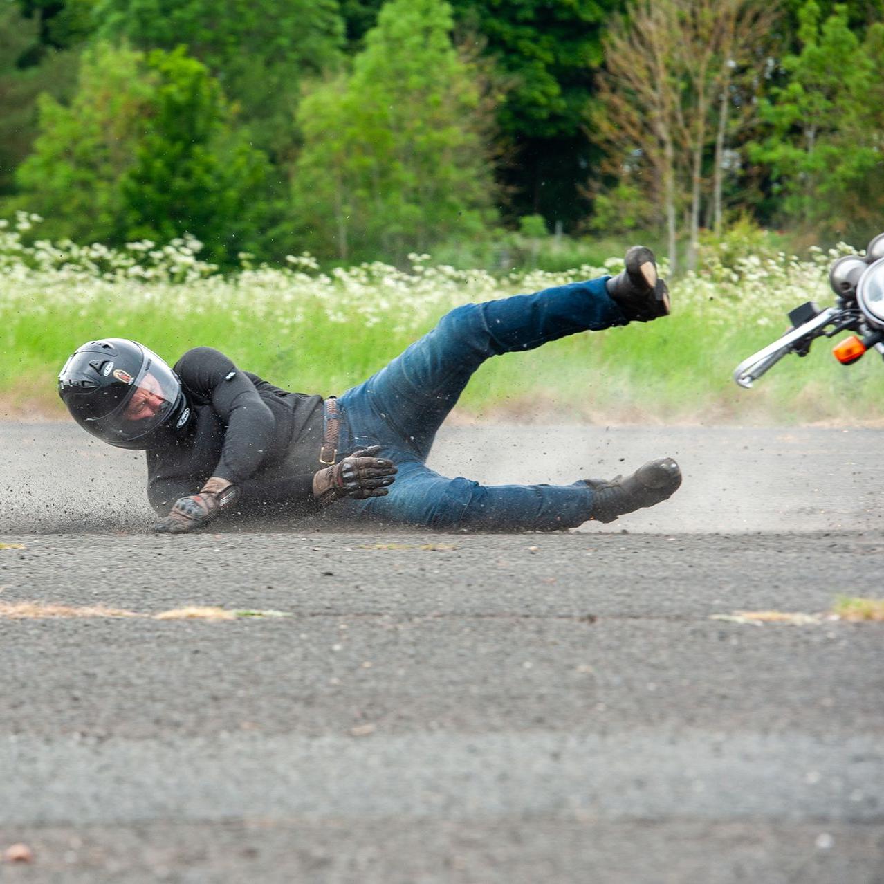 man wearing supershirt protective baselayer and no jacket sliding down road after crash